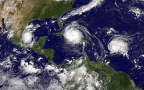 This satellite image shows three storms in the Atlantic: Hurricane Irma, Tropical Storm Jose, and Tropical Storm Katia, on September 8th.