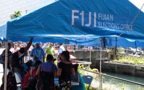 Workers from Fiji's elections office helping voters in downtown Suva ahead of polling day