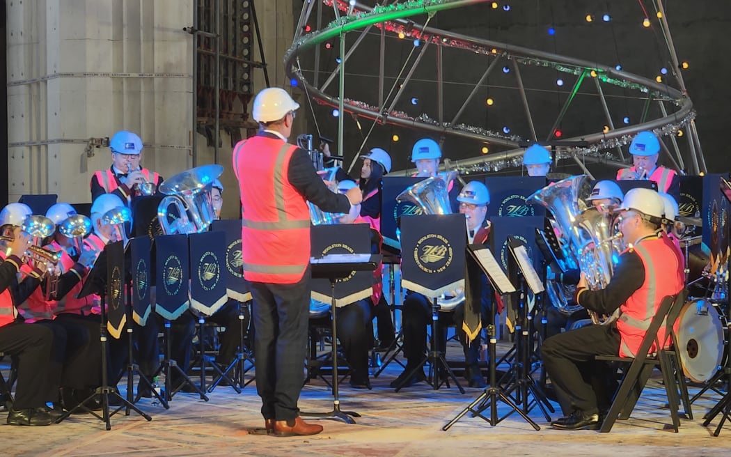 Woolston Brass band playing in the Christ Church Cathedral in front of the Christchurch City Mission Christmas tree. 
