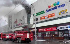 Emergency vehicles as they gather outside a burning shopping centre in Kemerovo.