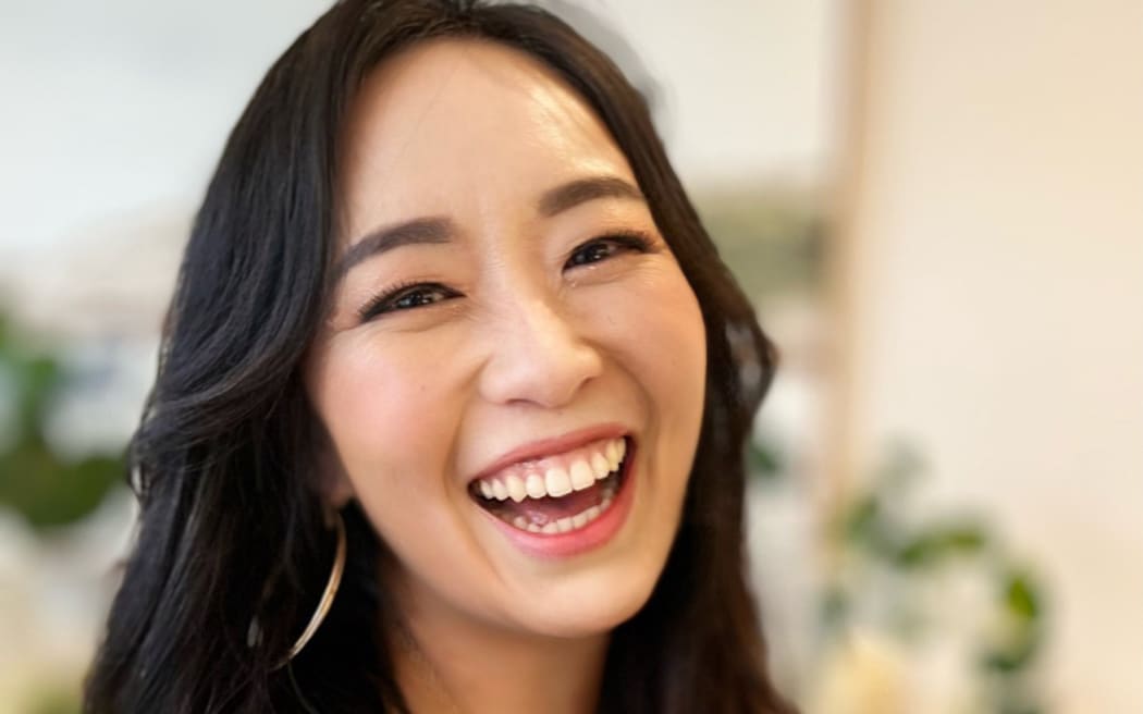 Graci Kim smiles widely at the camera.