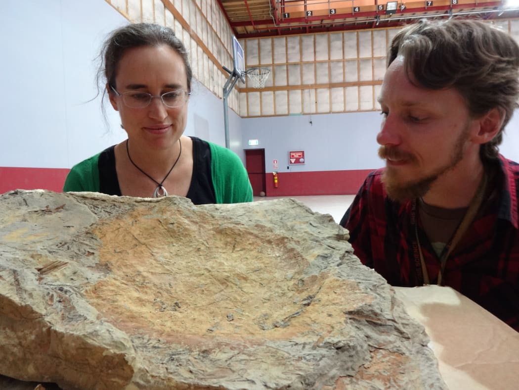 GNS Science palaeobotanist Liz Kennedy and expedition leader Chris Mays, from Monash University, with one of the large, fossil-bearing boulders from the Clarence Valley.