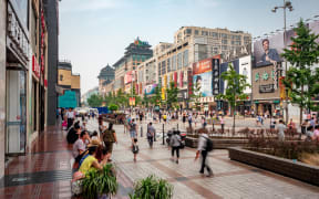 Beijing, China - June 28, 2017: Shoppers at Wangfujing Walking Street, the most well-known and prosperous shopping street in Beijing, capital of China.