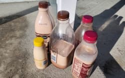 Some of the mysterious bottles of milk left at a fuel stop in Alexandra.