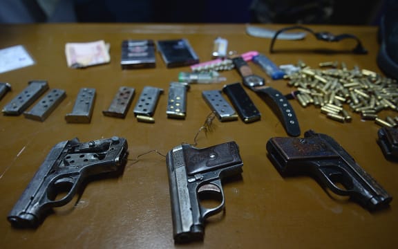 Handguns used by the attackers were displayed by officials.