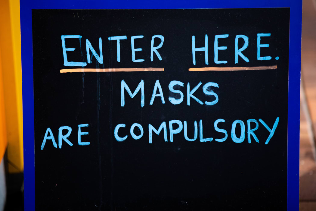 Sign outside a business which reads "Masks are compulsory"