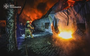 This handout photograph taken and released by Ukrainian State Emergency Service on March 26, 2025 shows firefighters putting out a fire following a drone strike in Kharkiv, amid the Russian invasion of Ukraine. (Photo by Handout / Ukraine's State Emergency Service / AFP) / XGTY / RESTRICTED TO EDITORIAL USE - MANDATORY CREDIT "AFP PHOTO / UKRAINE'S STATE EMERGENCY SERVICE" - NO MARKETING NO ADVERTISING CAMPAIGNS - DISTRIBUTED AS A SERVICE TO CLIENTS