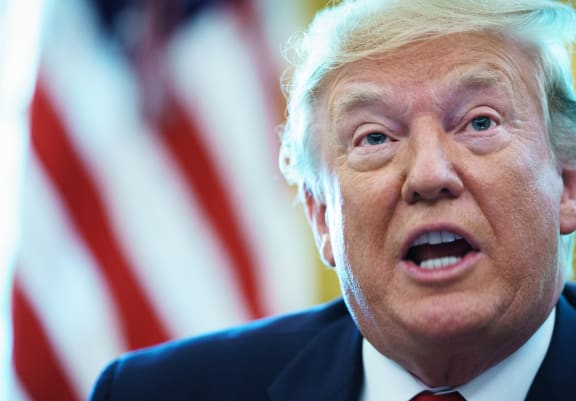 US President Donald Trump in the Oval Office before signing an executive order for sanctions on Iran's supreme leader.