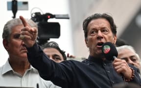Pakistan's former prime minister Imran Khan addresses his supporters during an anti-government march towards capital Islamabad, demanding early elections, in Gujranwala on 1 November 2022.
