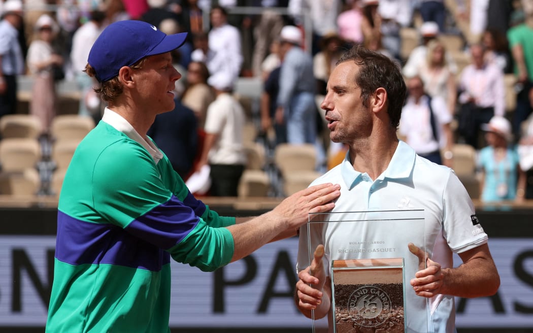 Italy's Jannik Sinner, left, speaks to retiring opponent Richard Gasquet after Sinner's victory in their second round match at the French Open.