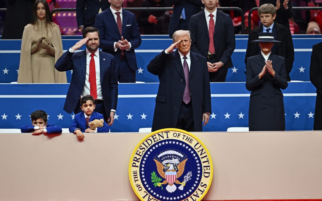 US President Donald Trump and US Vice President J.D. Vance salute during the inaugural parade inside Capital One Arena, in Washington, DC, on 20 January 2025.