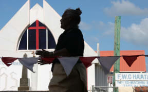 Tongan woman with church behind