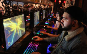 People play video games at the newly launched OS NYC, a fully equipped gaming lounge on September 19, 2019 in New York City. Re downloaded on 9 March 2020.