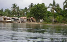 A man in a fishing canoe/boat in Bougainville, Papua New Guinea