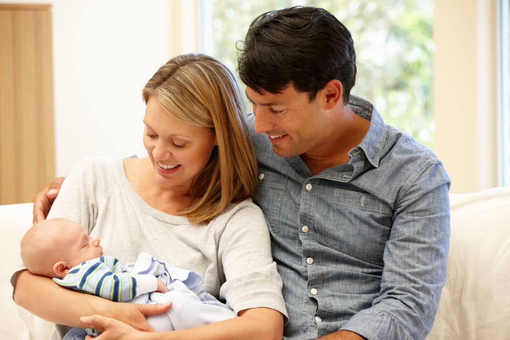 Couple at home with new baby
