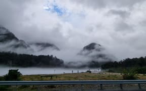 Blue sky attempts to peek through the clouds over the Waiho River.