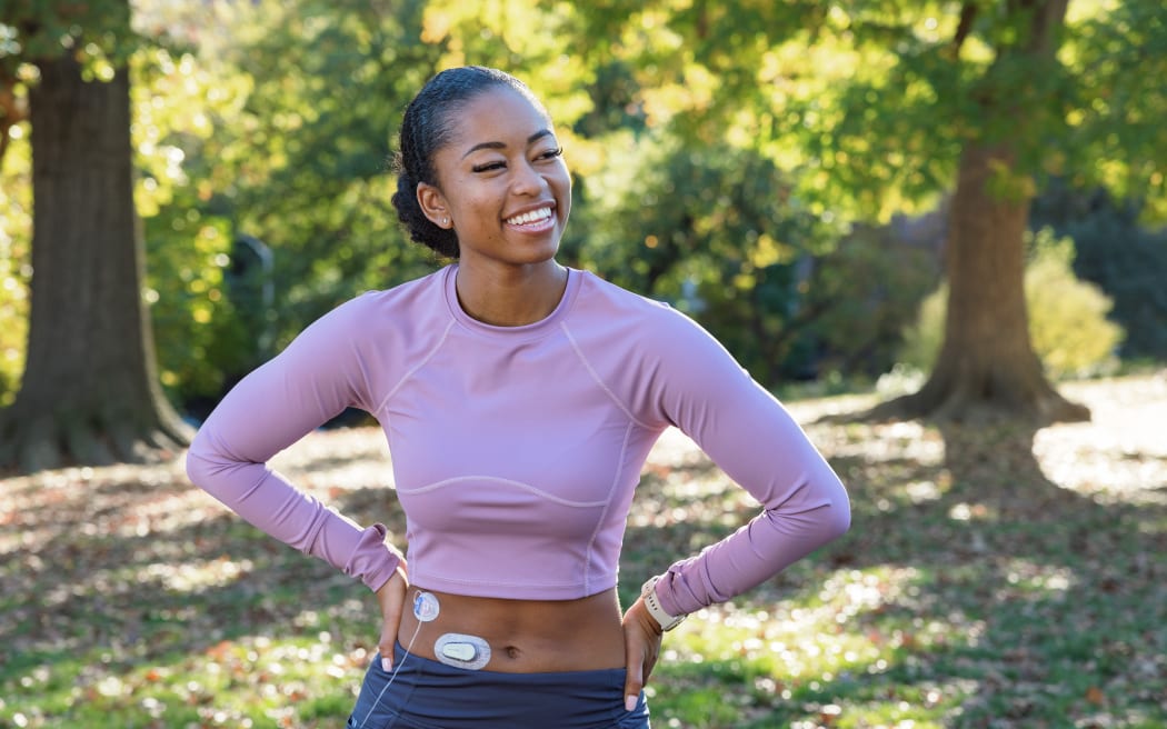A woman with diabetes wearing a Dexcom G6 continuous glucose monitor.