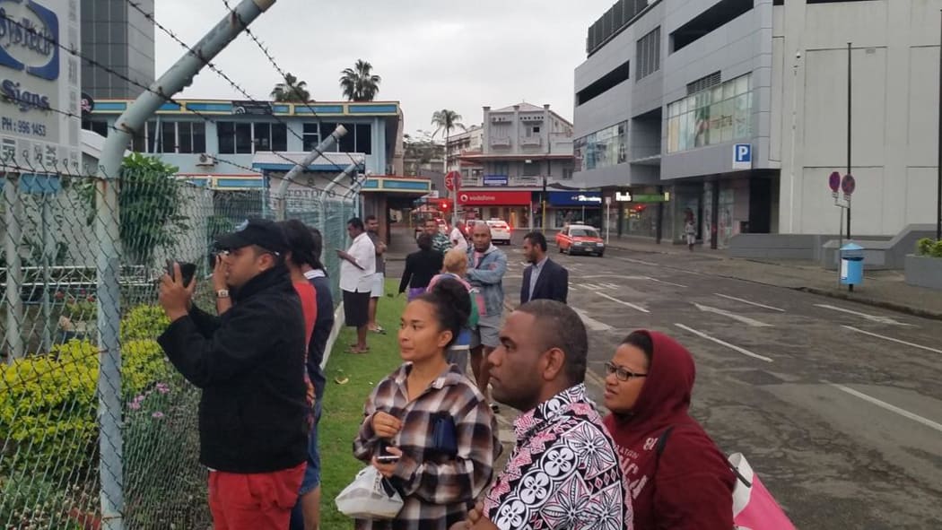 Supporters and media look on as the detainees head back inside again.