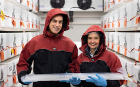 Nancy Bertler and Richard Levy hold an ice core collected from Antarctica which holds a record of past climate.