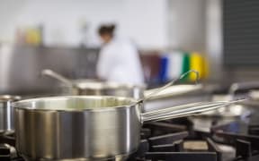 A cook in a professional kitchen.
