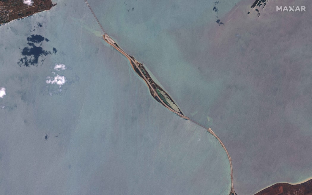 This handout satellite image taken and released by Maxar Technologies on July 17, 2023, shows the Kerch bridge, linking the Russian mainland to Crimea, where a section was damaged after an explosion claimed by Ukrainian forces. Waterborne drones struck the sole bridge connecting Russia to the annexed Crimea peninsula on July 17, in a deadly attack on a vital supply route claimed by Ukraine's security services. The explosion hit the Kerch bridge, a major conduit for Russia's troops in Ukraine, just hours before a crucial deal to export Ukrainian grain was to expire. (Photo by Satellite image ©2023 Maxar Technologies / AFP) / RESTRICTED TO EDITORIAL USE - MANDATORY CREDIT "AFP PHOTO / SATELLITE IMAGE ©2023 MAXAR TECHNOLOGIES" - NO MARKETING NO ADVERTISING CAMPAIGNS - DISTRIBUTED AS A SERVICE TO CLIENTS - RESTRICTED TO EDITORIAL USE - MANDATORY CREDIT "AFP PHOTO / Satellite image ©2023 Maxar Technologies" - NO MARKETING NO ADVERTISING CAMPAIGNS - DISTRIBUTED AS A SERVICE TO CLIENTS /
