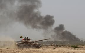 Iraqi government forces advance towards the centre of Saqlawiyah, north-west of Fallujah, to regain control of the area from the Islamic State group.