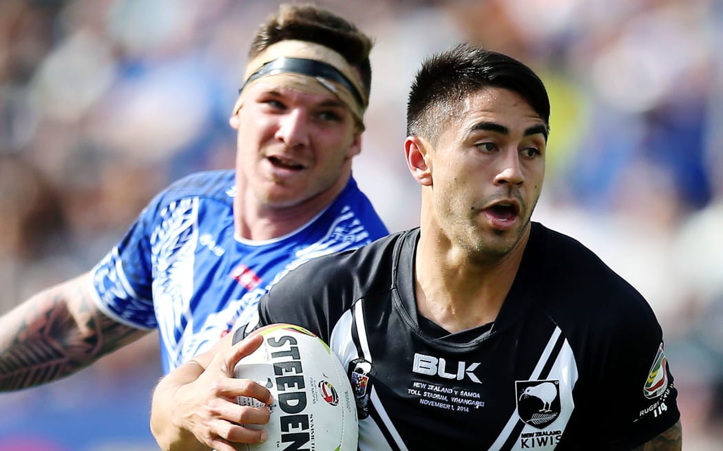 Shaun Johnson of New Zealand makes a break against Josh McGuire of Samoa.