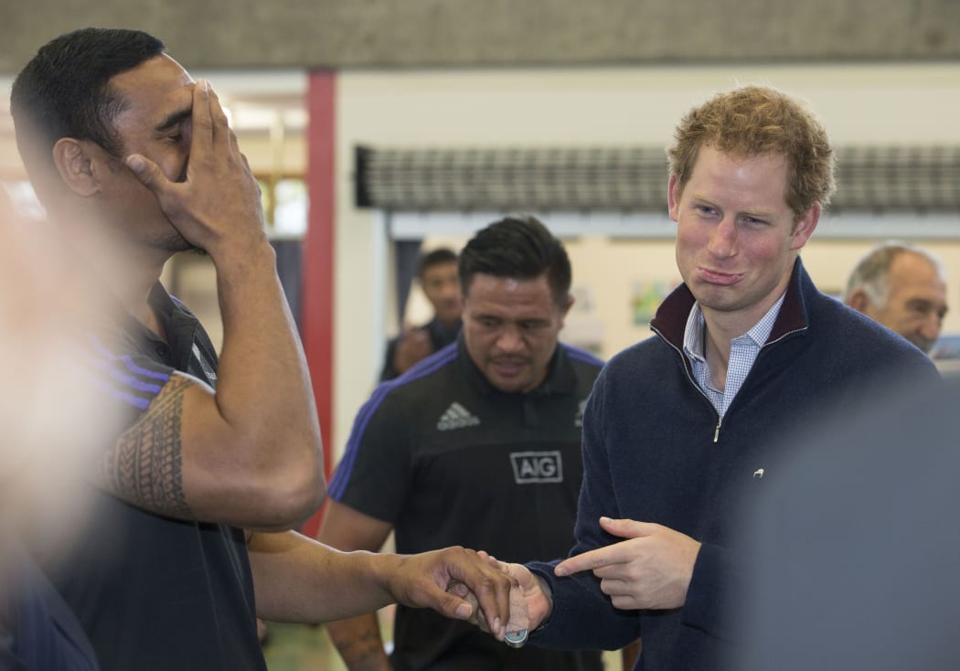 Prince Harry commiserates Jerome Kaino's injury, centre is Keven Mealamu.