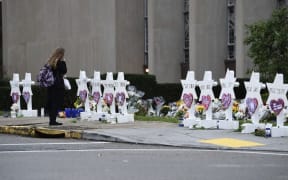 A woman stands at a memorial outside the Tree of Life synagogue in Pittsburgh after a shooting there left 11 people dead.