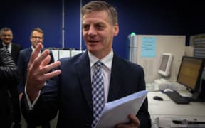 Bill English holding the 2015 Budget in Petone, Lower Hutt.