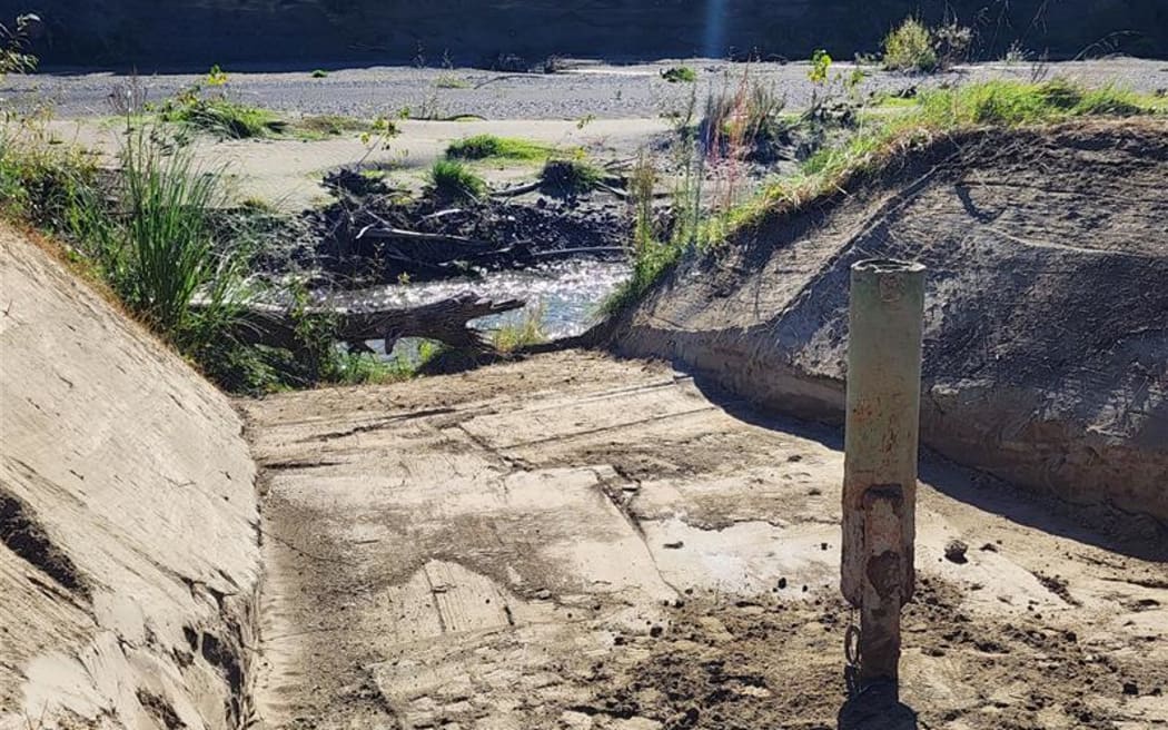 Daniel Gale's 'early warning system' was dug out of the silt after Cyclone Gabrielle. It has a float valve which alerts him when it is triggered by set river levels.