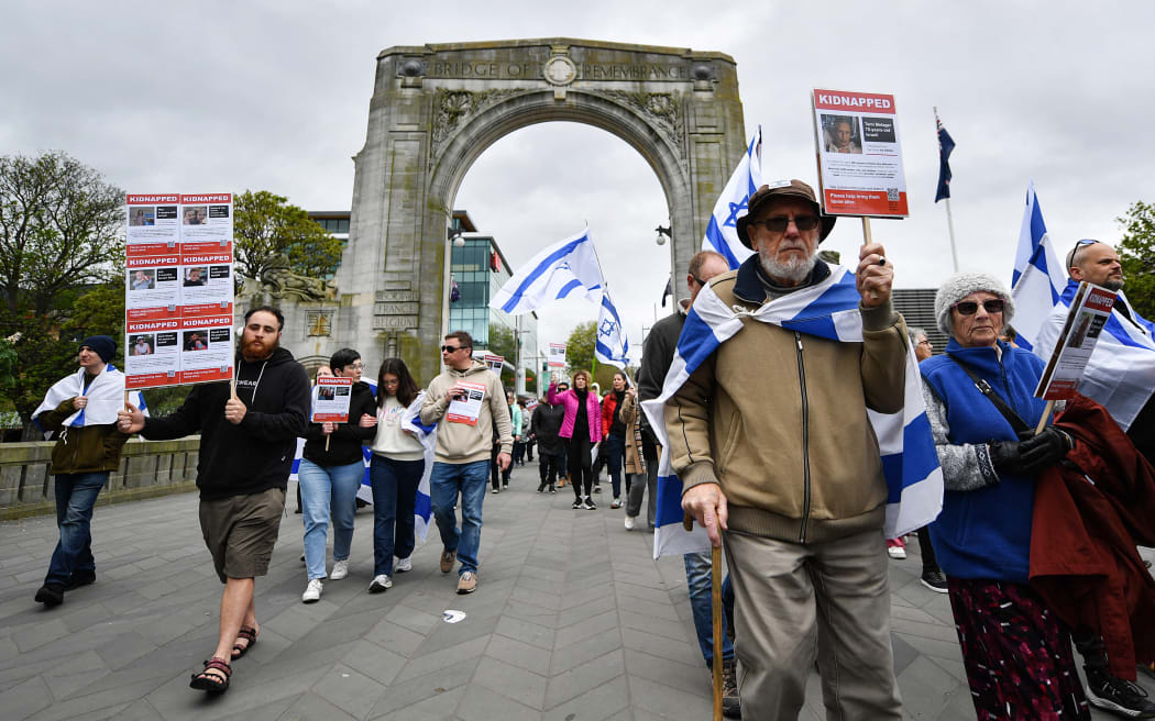 People take part in a pro-Israel rally in Christchurch on October 22, 2023. Thousands of people, both Israeli and Palestinians have died since October 7, 2023, after Palestinian Hamas militants based in the Gaza Strip, entered southern Israel in a surprise attack leading Israel to declare war on Hamas in Gaza the following day. (Photo by Sanka Vidanagama / AFP)