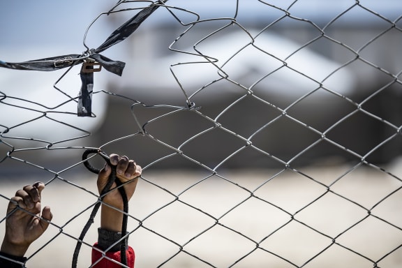 The hands of a Syrian child hooked at a fence at the al-Hol camp in al-Hasakeh governorate in Syria, on August 08, 2019.