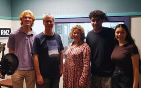 Bryan Crump in studio with members of The New Zealand Secondary Students Choir. From left to right: Teddy Finney-Waters, Bryan Crump, Music Director Sue Densem, Siaosi Lavelua, and Jasmine Hulton.