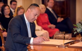 Australian Treasurer Josh Frydenberg signs a document during an oath-taking ceremony at Government House in Canberra on May 29, 2019.