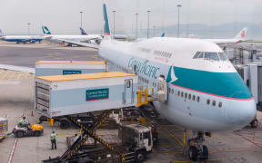 Cathay Pacific Airplane docked getting ready to flight at Hong Kong International airport.