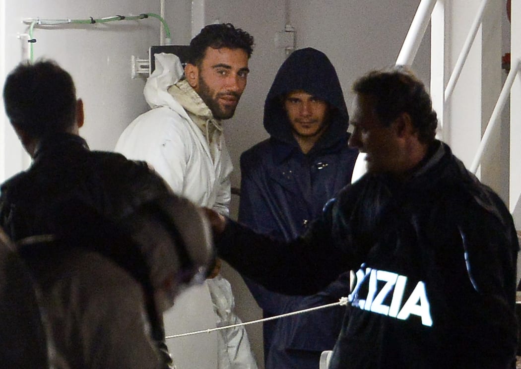Mohammed Ali Malek (L), the captain of the migrant boat that capsized in the Mediterranean sea killing 700, pictured on the Italian coastguard's ship after being rescued.