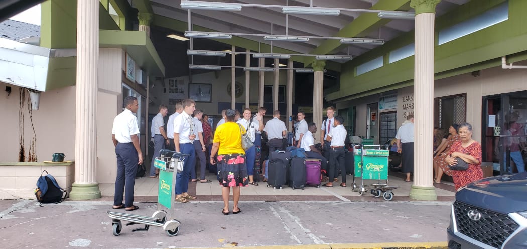 LDS church missionaries are joined by well-wishers at Amata Kabua International Airport in Majuro