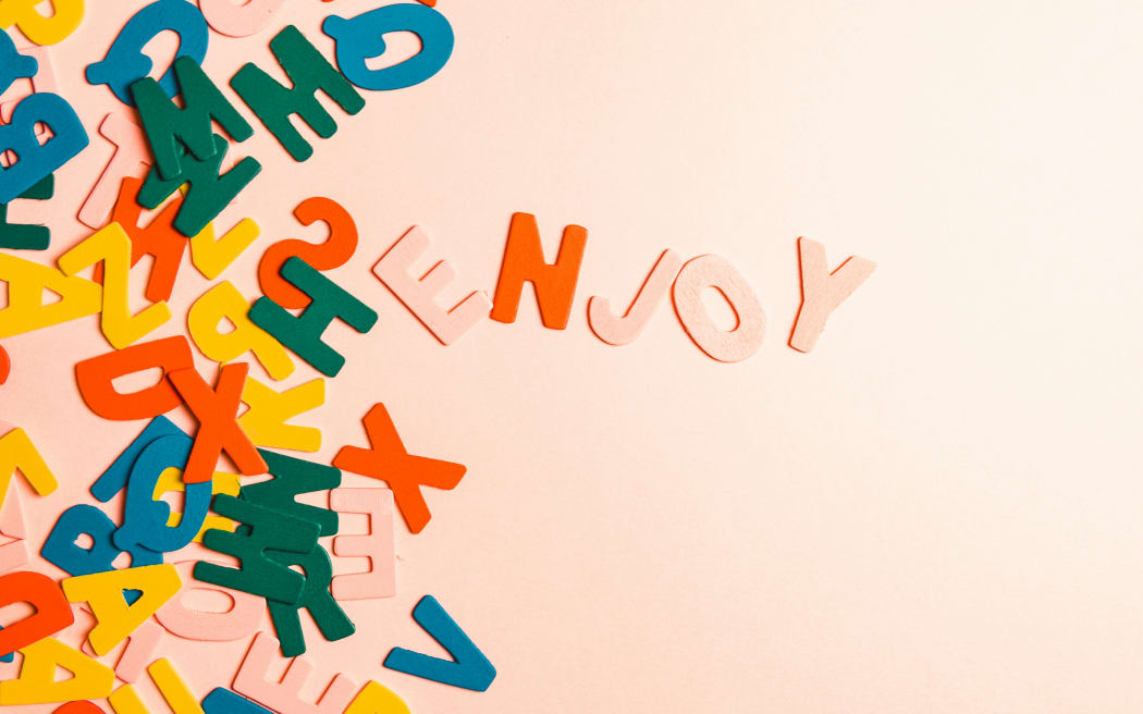 random colourful letters on a pink background