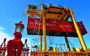 Straddle carriers and containers on Fergusson Wharf at Ports of Auckland.