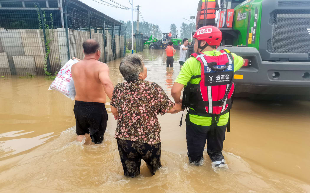 Rescue teams evacuate people trapped in Diao Town, Zhuozhou city, Baoding city, Hebei province, China, August 3, 2023. Under the influence of Super Typhoon Doksuri, heavy rain has hit the Beijing-Tianjin-Hebei region. The average rainfall in Zhuozhou is 398 mm. (Photo by Costfoto/NurPhoto) (Photo by CFOTO / NurPhoto / NurPhoto via AFP)