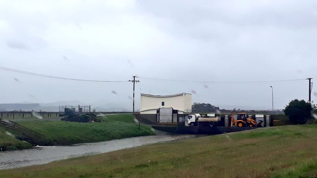 Council workers keeping one of Napier's main stormwater drains clear where it enters Pandora Estuary