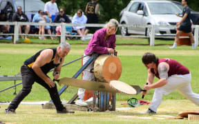 A team saw through a log at a previous Tūātapere Sports Day.