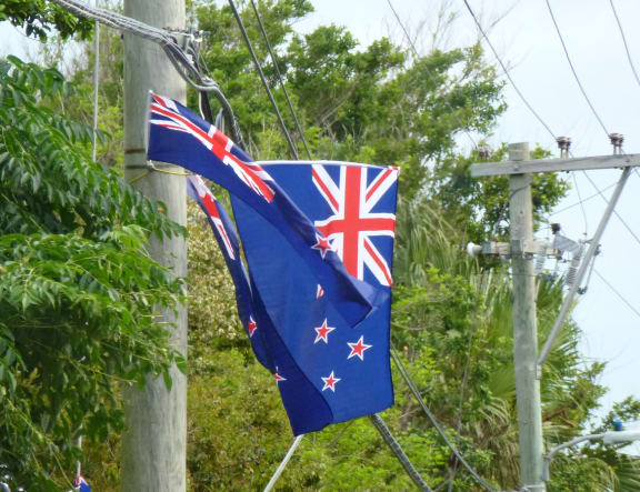 Dozens of New Zealand flags have appeared in Bermuda, despite the host country officially backing Oracle Team USA.