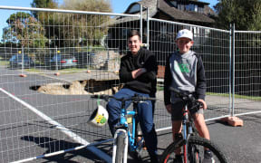Jono Park (left) and Bailey Malloy (right) in front of the sinkhole in Taupō.