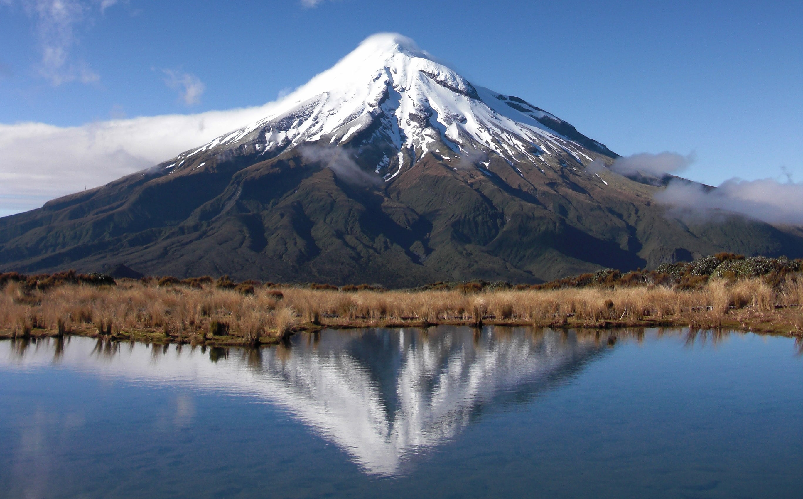 A view of Mt Taranaki over a waterway.