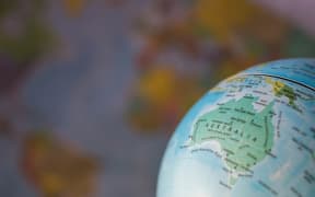 Australia map on a globe with earth map in the background