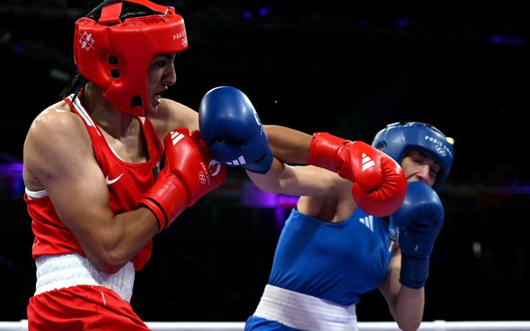 Algeria's Imane Khelif (in red) punches Italy's Angela Carini in the women's 66kg preliminaries round of 16 boxing match during the Paris 2024 Olympic Games at the North Paris Arena, in Villepinte on August 1, 2024. (Photo by MOHD RASFAN / AFP)