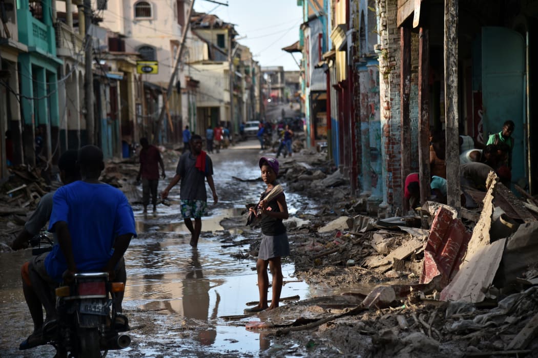 A girl walks on a street damaged in Hurricane Matthew, in Jeremie, western Haiti