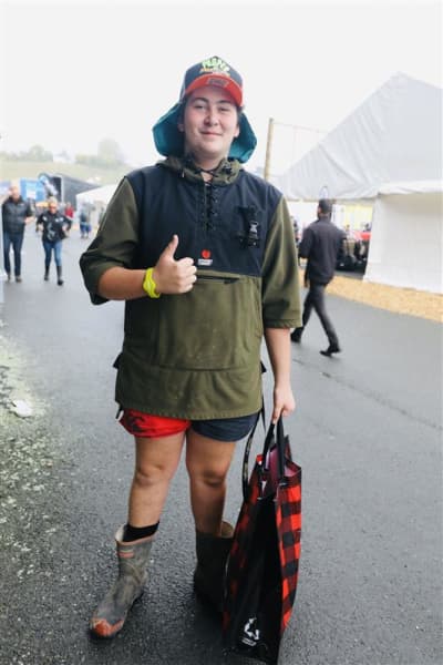 Michael Greathead from Pukekohe wearing a cap with a neck flap, Red Band gumboots, and a Stoney Creek shirt at Fieldays on 12 June, 2025.